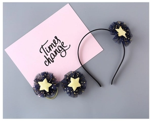 Detailed view of children's navy blue star mesh headband and matching hair tie set