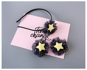 Detail of star-themed hair accessories set with navy mesh fabric and gold star prints