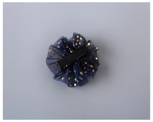 Close-up of navy blue star mesh hair clip with golden sequins and fabric-wrapped base