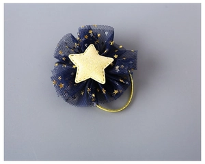 Macro view of navy blue mesh flower hair tie with yellow glitter star and gold elastic band