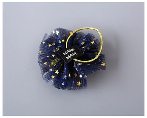 Detail of dark blue mesh hair tie with gold stars and Hand Made label for girls