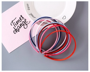 Close-up of assorted colorful 1cm fabric covered plastic headbands in satin finish
