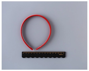 Detail view of 1cm red fabric covered headband with a scale ruler for size measurement