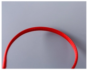 Close-up of red fabric headbands showing detailed stitching and satin texture detail