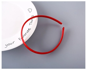 Close-up of a 1cm slim red fabric covered headband for DIY hair accessories on grey background
