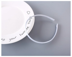 Close-up of 1cm light blue fabric covered plastic headband with fine woven texture