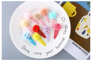 Detailed set of 10 colorful mesh flower snap hair clips for children in a white tray