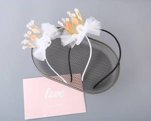 Close-up of sparkling crown headband with lace mesh and beads for girls party