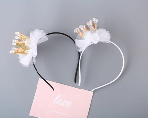 Close-up of glitter crown headbands with white mesh and beads for girls' parties