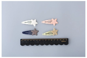 Detailed view of 5cm glitter star hair clips in four colors with a sizing ruler