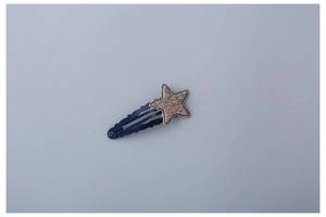 Close-up of a blue glitter star hair clip for kids with a sparkling finish and wavy base