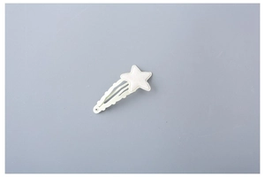 Close-up of a cream white star hair clip for girls with a wavy edge and glitter finish