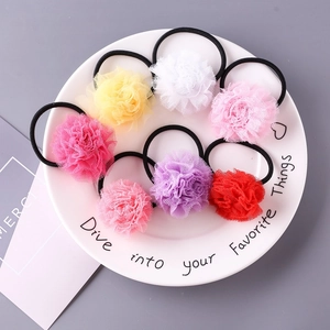 Vue détaillée de pinces à cheveux fleurs en tulle coloré pour filles dans une assiette