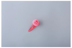 Detailed view of a bright pink fabric flower hair clip for girls with a metal snap pin