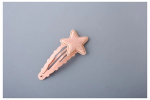 Close-up of pink glitter star hair clip with matching wave-edge BB clip for girls