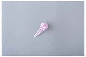 Close-up of a sweet lavender purple fabric flower hair clip for girls with painted metal base