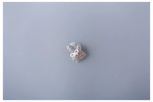 Close-up of a cute grey glitter bunny hair clip with a small white bow decoration