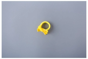 Close-up of yellow velvet bow hair tie for kids with high elastic band detail