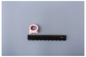 Close-up of pink velvet bow hair tie with a ruler showing the 3cm small size detail