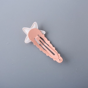 Children's glitter star hair clip with pink wavy metal base on a blue background