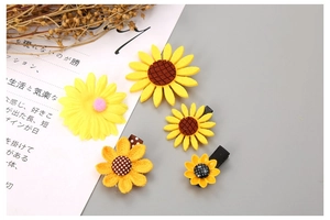Flat lay of sunflower hair clips set with various yellow petals and cute floral designs