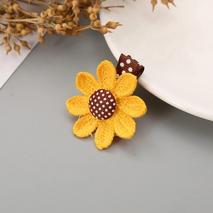 Handcrafted sunflower hair clip for girls with yellow petals and polka dot fabric detail