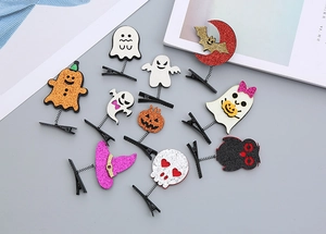 Flat lay of twelve assorted sequined Halloween hair clips with pumpkin and ghost motifs
