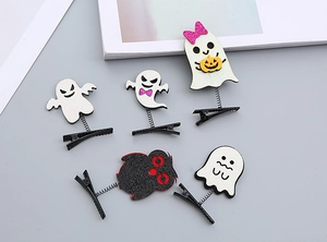 Close-up of five Halloween hair clips with glitter ghosts and monsters on spring clips