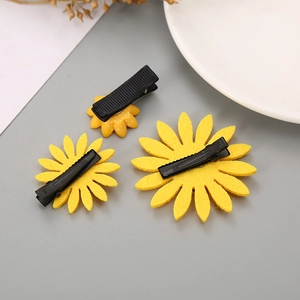 Three-piece sunflower hair clip set featuring yellow resin and felt floral designs