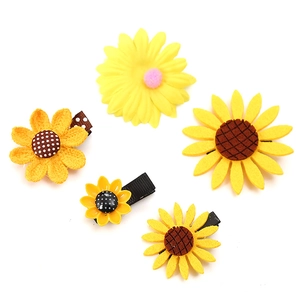 Set of five vibrant sunflower hair clips for kids featuring woven and felt textures
