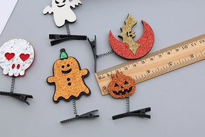 Detail showing various Halloween spring hair clips with a ruler measuring 3.5cm width