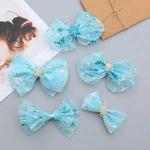 Detailed set of blue mesh bow hair clips with silver snowflake charms for girls
