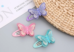 Detail of sparkling rhinestone butterfly hair clips with layered wings for girls