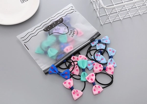 Detailed set of colorful polka dot bow hair ties with a cute portable zipper storage bag