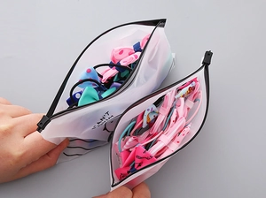 Translucent zipper storage bag filled with colorful floral bow hair ties for girls