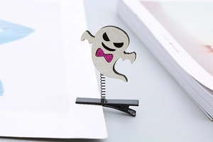 Close-up of white sequined ghost hair clip with a purple bow on a dynamic metal spring