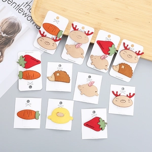 Detail of handmade felt hair clips for girls featuring cute strawberry and animal shapes