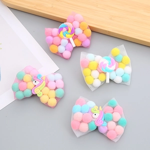 Kids hair clip set featuring rainbow lollipop and unicorn bows with colorful pom poms
