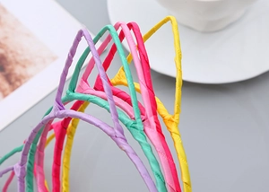 Detail view of colorful fabric wrapped cat ear headbands in vibrant candy tones