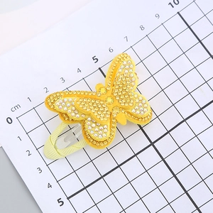 Glittering yellow butterfly hair clip with rhinestones and ribbon-wrapped metal base