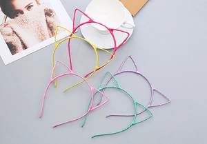 Flat lay of colorful cat ear headbands in rose, yellow, green and purple colors