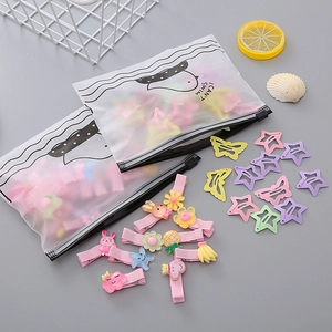 Detailed close-up of colorful resin hair clips and cute fruit charms in gift packaging