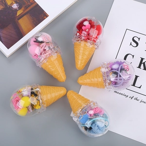 Close-up of five ice cream shaped containers with colorful kids hair accessories and clips