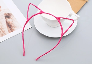 Detailed view of kids cat ear headband wrapped in premium pink polyester fabric