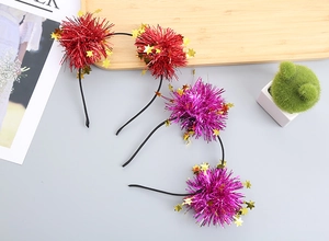 Detail of festive headbands with tinsel pompoms and gold stars in red and purple