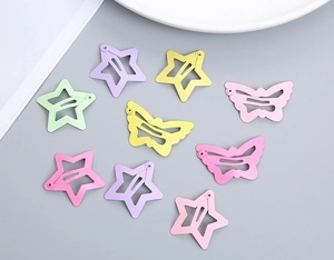 Flat lay of pastel matte metal hair clips in star and butterfly shapes for girls