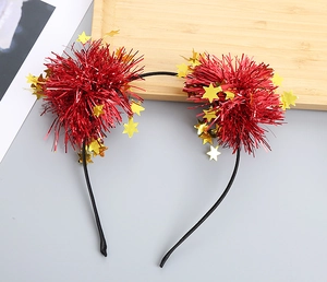 Detail of festive headgear with red tinsel balls and gold stars on a black headband