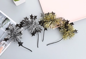 Detail of festive gold and silver glitter star headbands for kids party accessories