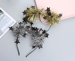 Close-up of sparkling gold and silver tinsel headbands with black star accents for parties