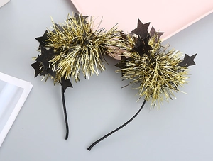 Detail view of party headbands featuring dense golden tinsel balls and black star decorations